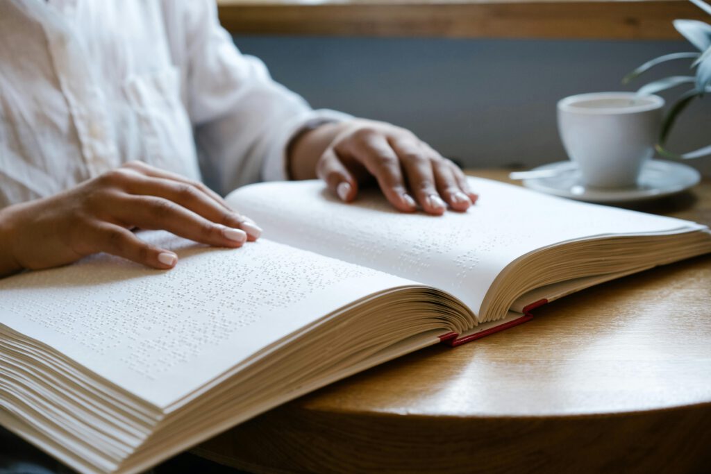 A Person Touching a Braille Book